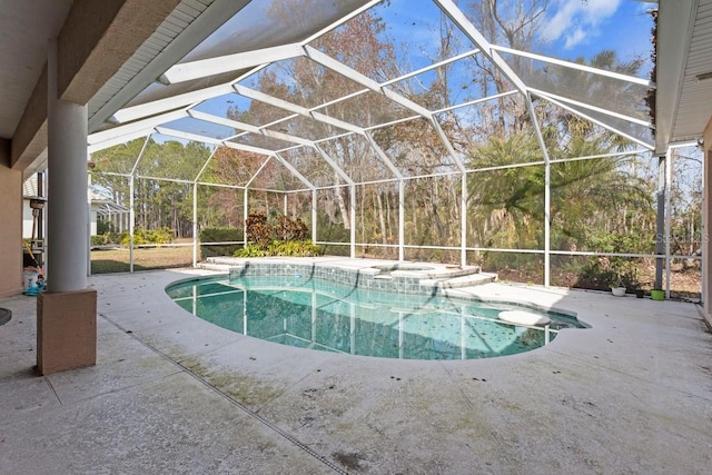 view of swimming pool featuring a patio, a lanai, and a pool with connected hot tub