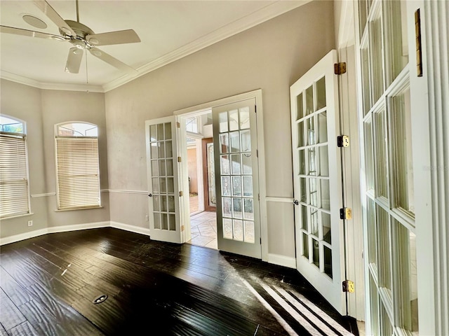 unfurnished sunroom featuring a ceiling fan and french doors