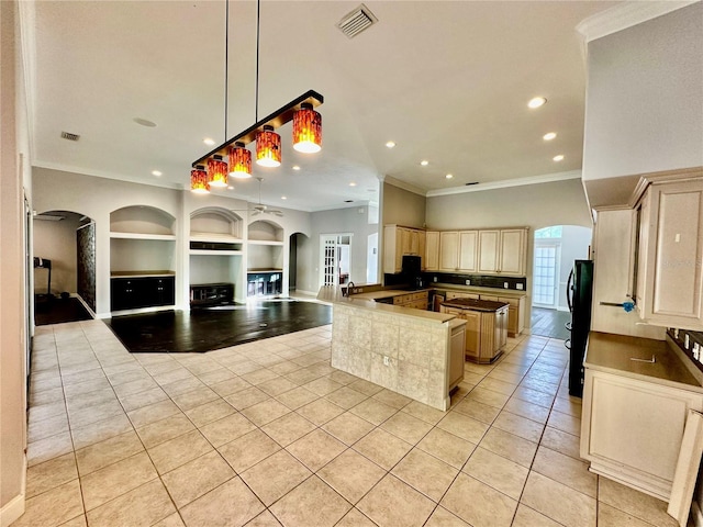 kitchen with light tile patterned floors, visible vents, open floor plan, freestanding refrigerator, and built in shelves