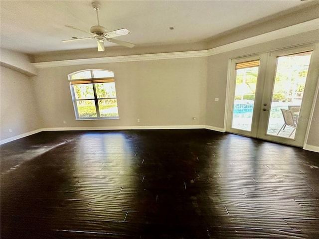 spare room featuring ceiling fan, baseboards, french doors, dark wood-style floors, and crown molding