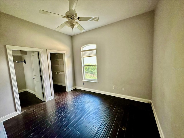 unfurnished bedroom with ceiling fan, baseboards, and dark wood-style flooring