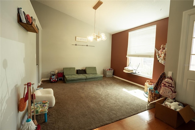 interior space with an inviting chandelier, vaulted ceiling, and carpet