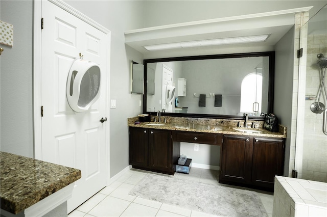 bathroom featuring tile patterned flooring, vanity, and an enclosed shower