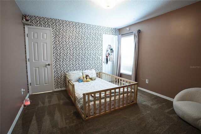 carpeted bedroom featuring a textured ceiling