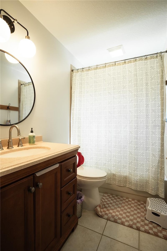 full bathroom with vanity, tile patterned floors, shower / bath combination with curtain, and toilet