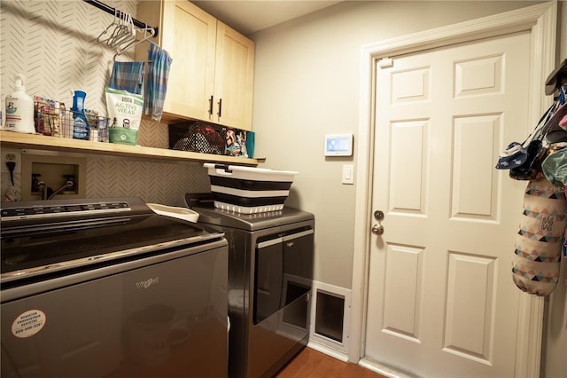 laundry area with cabinets, dark hardwood / wood-style flooring, and independent washer and dryer