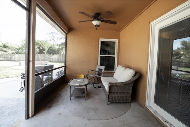 sunroom / solarium featuring ceiling fan