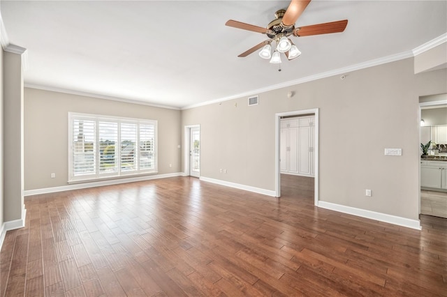 unfurnished living room with baseboards, visible vents, dark wood finished floors, ceiling fan, and ornamental molding