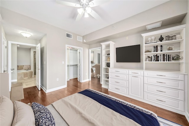 bedroom featuring baseboards, visible vents, dark wood-style flooring, a spacious closet, and a closet