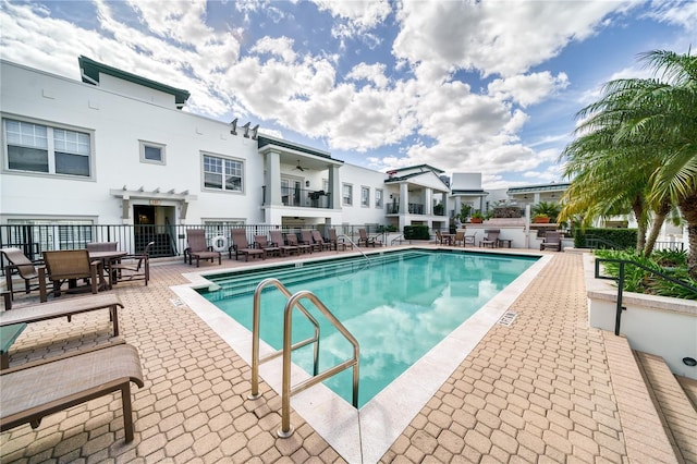 pool featuring a patio and fence