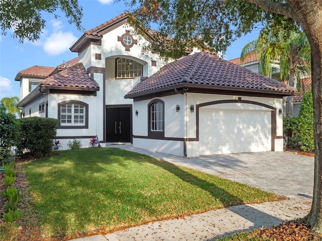 mediterranean / spanish-style home featuring a garage and a front lawn