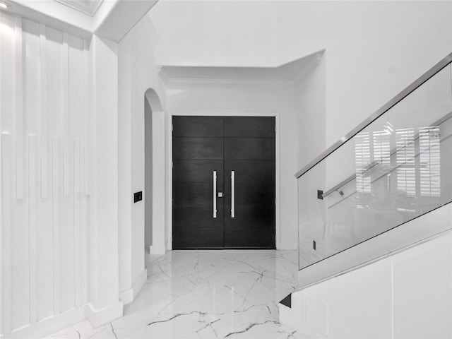 entryway featuring french doors and ornamental molding