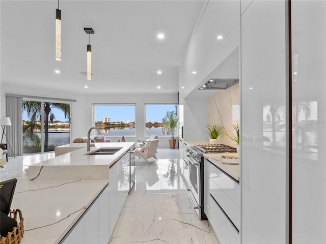 kitchen with decorative light fixtures, white cabinetry, high end range, a water view, and light stone countertops