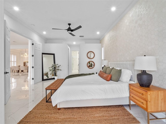 bedroom with ornamental molding, ceiling fan, and ensuite bathroom