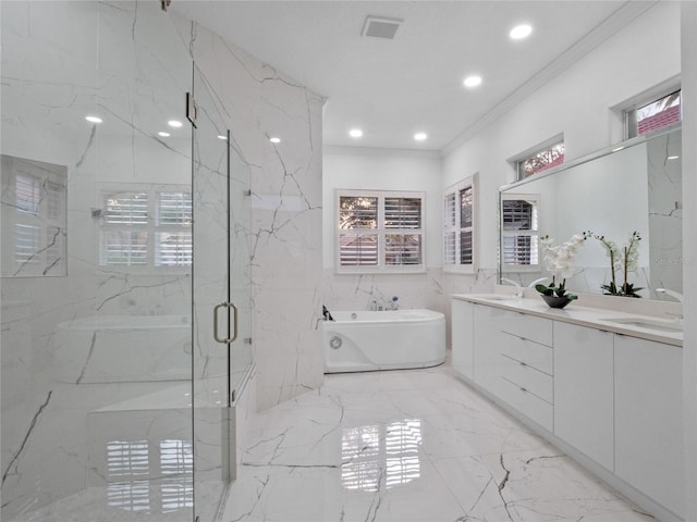 bathroom featuring crown molding, vanity, shower with separate bathtub, and tile walls