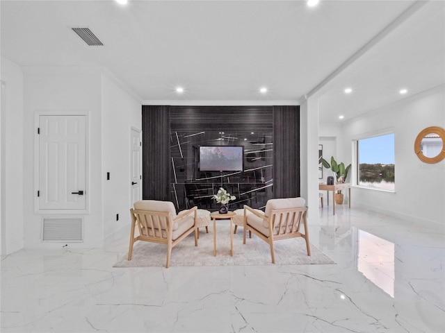 living area featuring ornamental molding