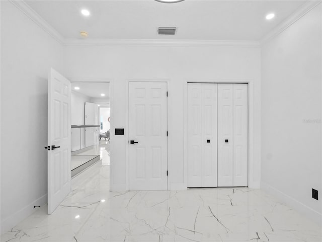 unfurnished bedroom featuring crown molding and a closet