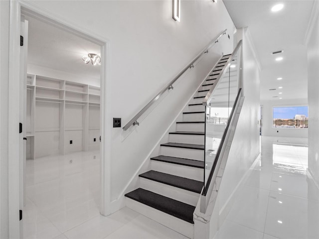 staircase with tile patterned floors