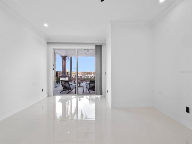 spare room featuring ornamental molding and light tile patterned floors