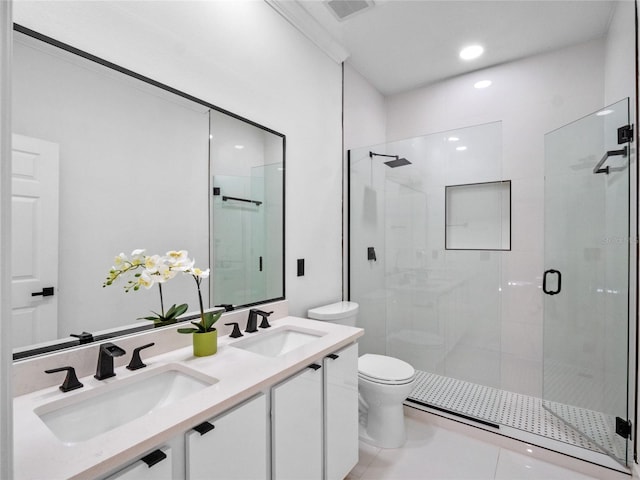 bathroom featuring tile patterned floors, vanity, toilet, and an enclosed shower