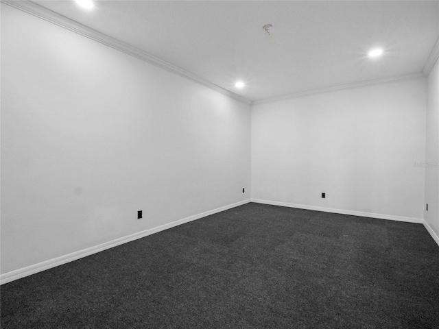 spare room with dark colored carpet and crown molding