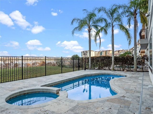 view of swimming pool with an in ground hot tub and a patio area