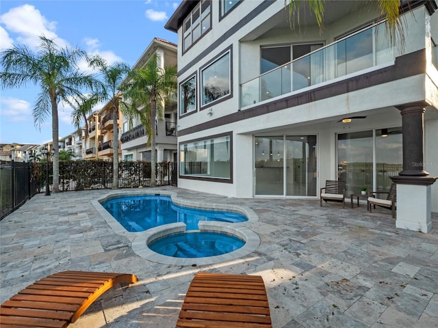 view of swimming pool featuring an in ground hot tub and a patio