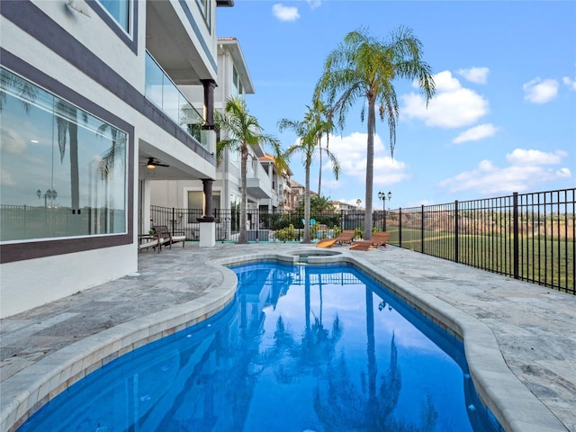 view of swimming pool featuring an in ground hot tub and a patio