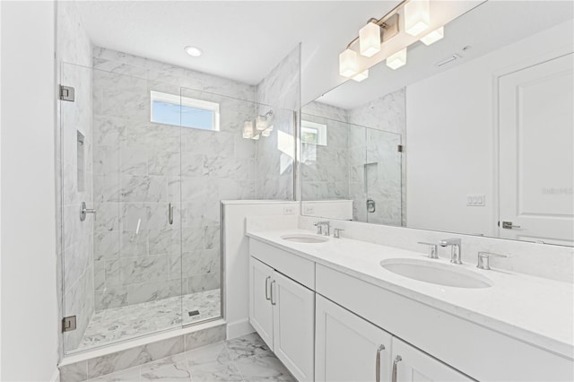 bathroom featuring vanity and a shower with door