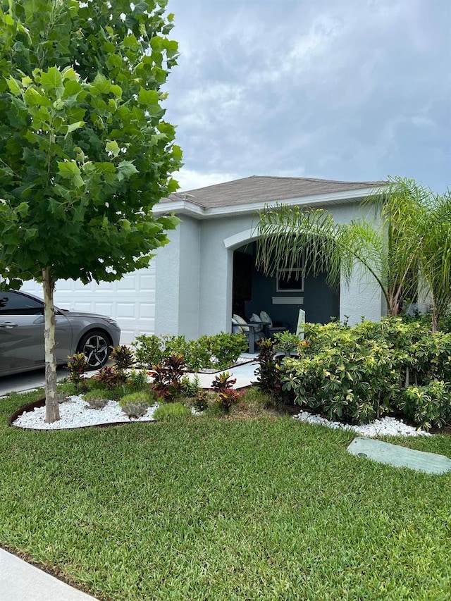 view of home's exterior featuring a garage and a yard