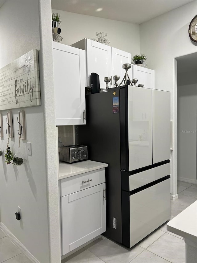 kitchen with white cabinetry and light tile patterned floors