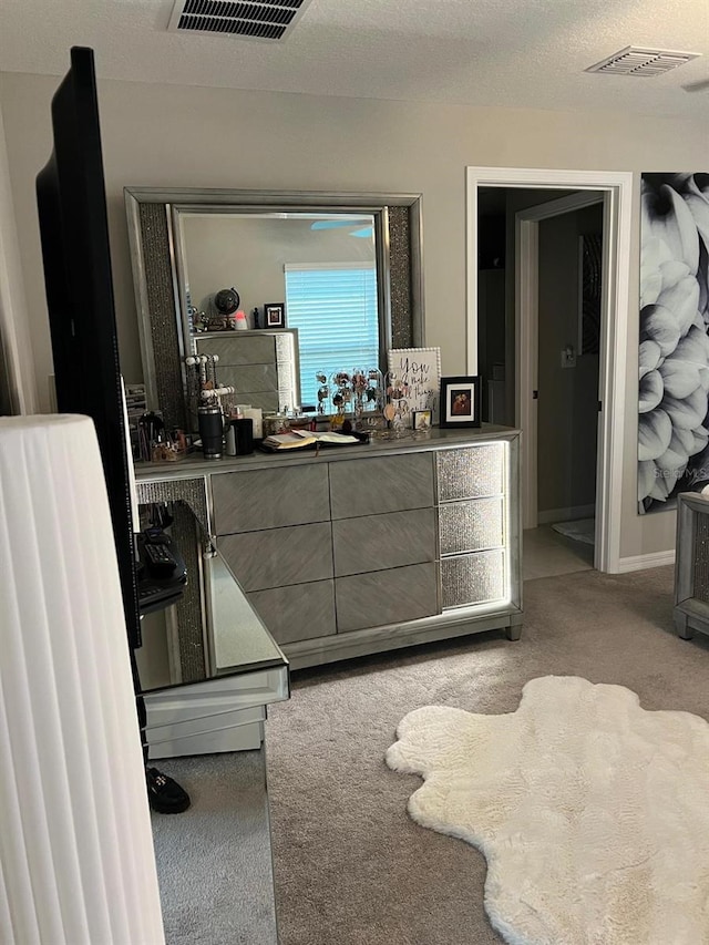 carpeted bedroom with a textured ceiling