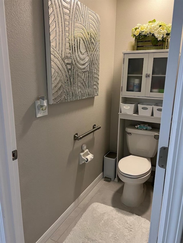 bathroom with tile patterned flooring and toilet