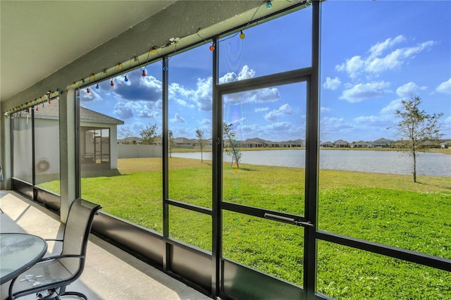 unfurnished sunroom featuring a water view