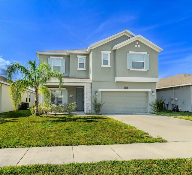 view of front of property with a garage and a front lawn