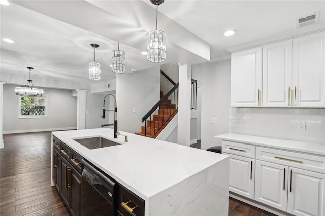 kitchen featuring a center island with sink, white cabinetry, dishwasher, and sink