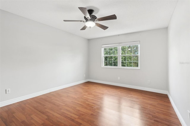 unfurnished room with hardwood / wood-style floors and ceiling fan