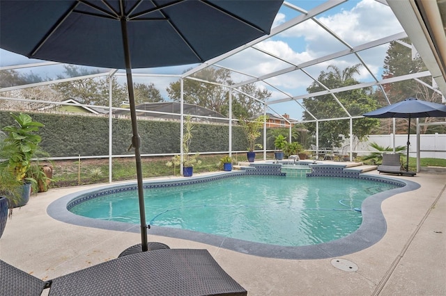 view of swimming pool with glass enclosure and a patio area