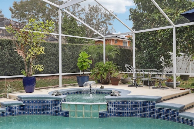 view of swimming pool with a lanai, a patio area, and pool water feature