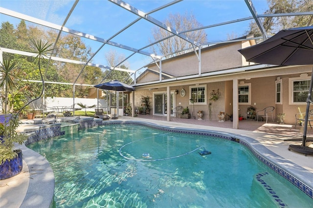 view of swimming pool with a patio, a lanai, and pool water feature