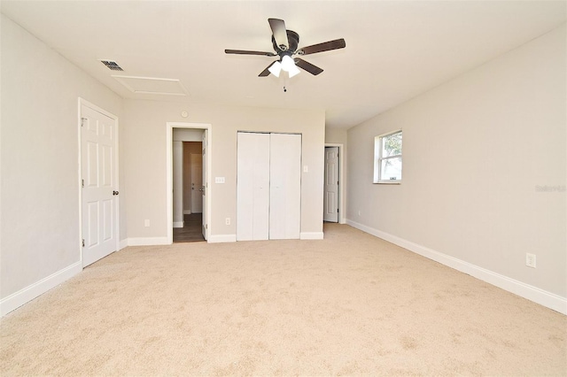 unfurnished bedroom featuring light carpet and ceiling fan