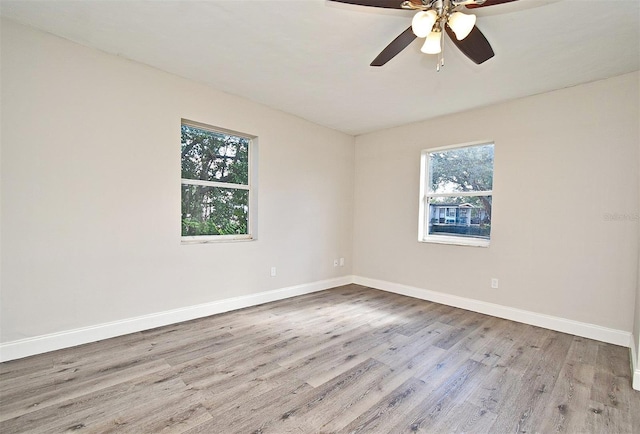 empty room featuring ceiling fan and light hardwood / wood-style floors