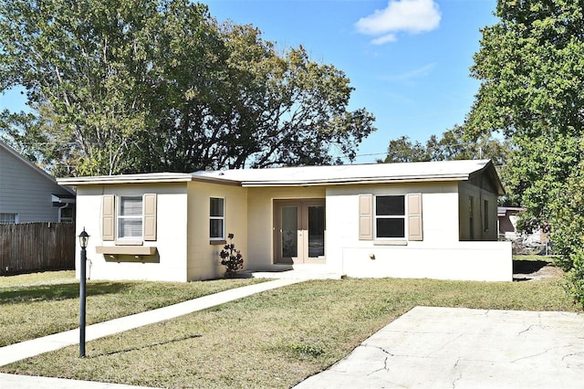 view of front of home featuring french doors and a front lawn