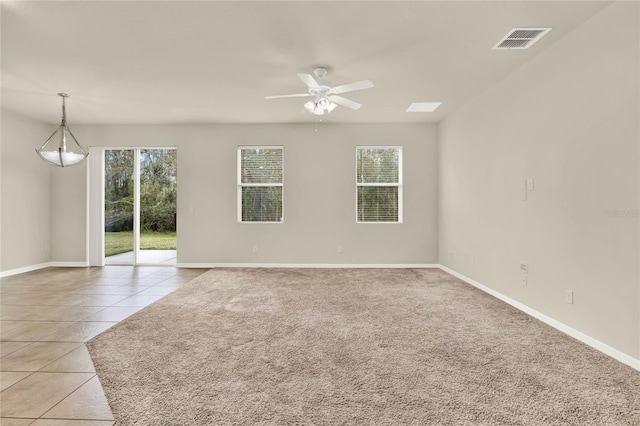 tiled empty room featuring ceiling fan