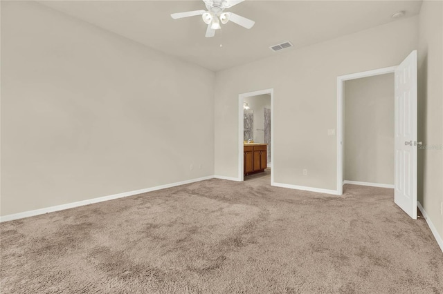 unfurnished bedroom with light carpet, ensuite bath, and ceiling fan