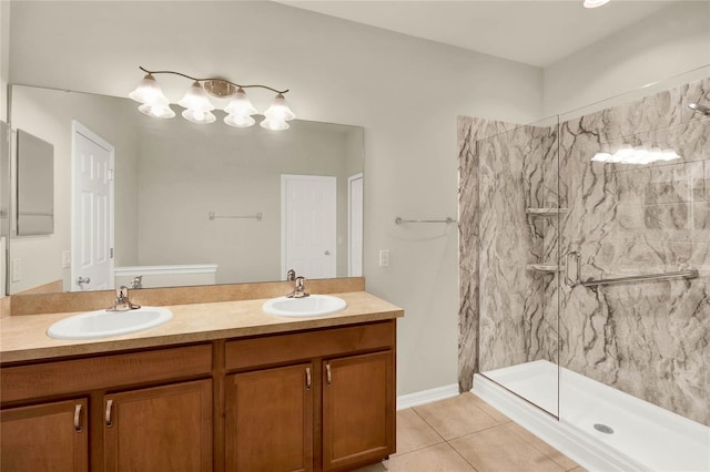 bathroom featuring tiled shower, vanity, and tile patterned flooring