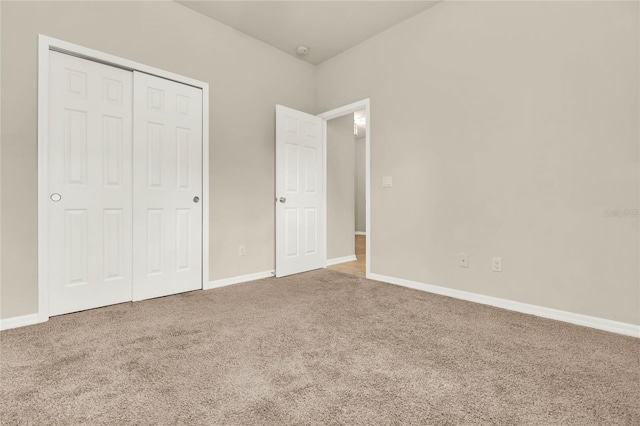 unfurnished bedroom with carpet floors and a closet