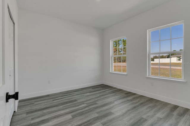 unfurnished room with hardwood / wood-style floors