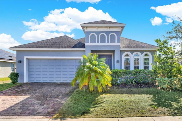 view of front of home featuring a garage and a front lawn