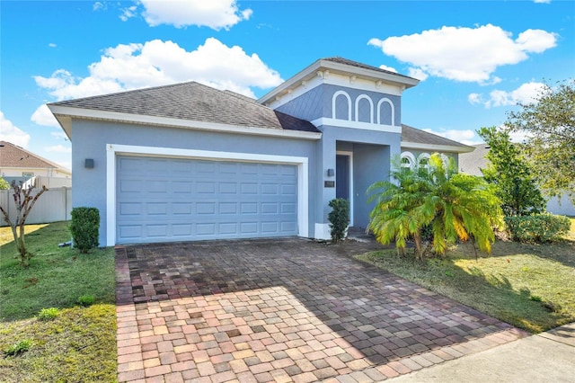 view of front of house with a garage and a front lawn